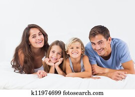 Happy family lying on a bed