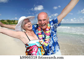 Happy senior couple at tropical beach