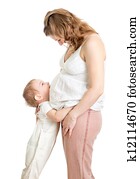 Little boy hugging pregnant mother's belly and looking up