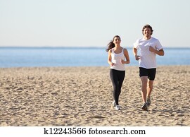 Man and woman running in the beach