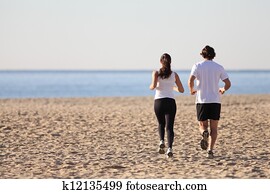 Man and woman running in the beach