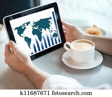 Man holding tablet computer in cafe