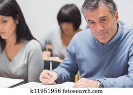Man taking notes in a lecture Man taking notes in a lecture