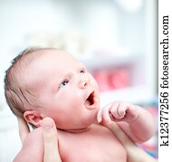 Newborn baby with look of wonderment