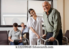 Nurse Helping Senior Patient With Walker