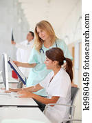 Nurse with intern working in front of computer Nurse with intern working in front of computer