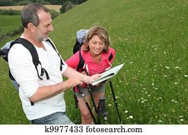 Retired people reading map on trekking day