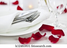 Romantic dinner setting with rose petals Romantic dinner setting with rose petals