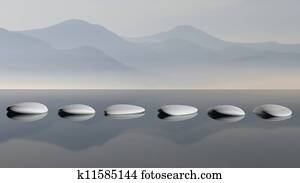 Scenic view of lake with mountain reflections and Zen stones in the water Scenic view of lake with mountain reflections and Zen stones in the water