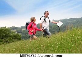 Senior couple hiking in natural landscape Senior couple hiking in natural landscape