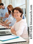 Senior woman attending business training