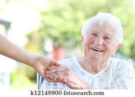Senior Woman Holding Hands with Caretaker Senior Woman Holding Hands with Caretaker
