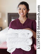 Smiling maid with towels Smiling maid with towels
