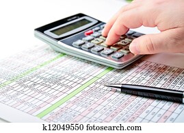 Tax forms, spread sheet with pen and calculator.