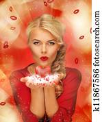 woman blowing kisses on the palms of her hands woman blowing kisses on the palms of her hands