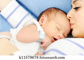 Woman holding her newborn baby at hospital Woman holding her newborn baby at hospital