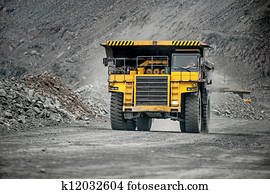 Yellow mining vehicle driving in the pit Yellow mining vehicle driving in the pit