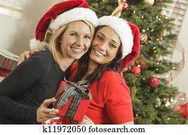 Young Mixed Race Girlfriends with Christmas Gift