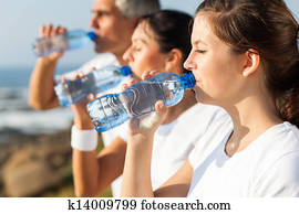 active family drinking water after jogging