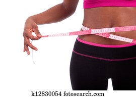 African American Fitness woman measuring her belly African American Fitness woman measuring her belly