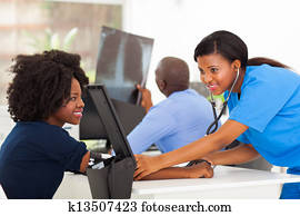 african nurse checking patient's blood pressure