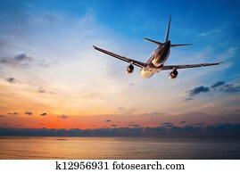 Airplane flying at sunset Airplane flying at sunset
