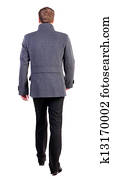 Back view of going  handsome business man in coat. 