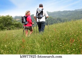 Back view of senior couple hiking in countryside