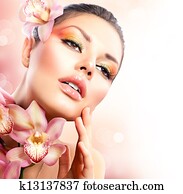 Beautiful Spa With Orchid Flowers Touching her Face