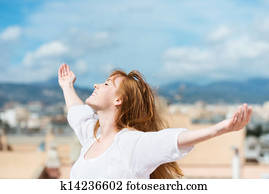 Beautiful woman rejoicing in the sunshine