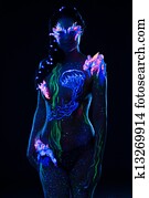 Beautiful woman with body art glowing in ultraviolet light Beautiful woman with body art glowing in ultraviolet light