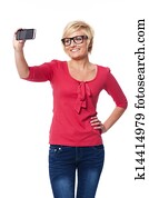 Blonde woman wearing glasses taking self portrait photo