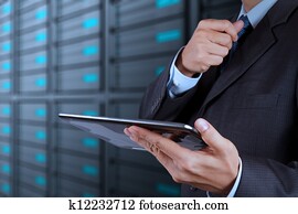 businessman hand using tablet computer and server room businessman hand using tablet computer and server room