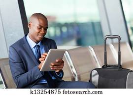 businessman using tablet computer airport