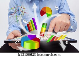 Businessman working on tablet computer - producing charts Businessman working on tablet computer - producing charts