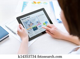 Businesswoman reading latest news