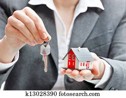 Businesswoman with house model and keys