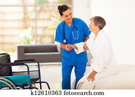 caregiver helping senior woman 