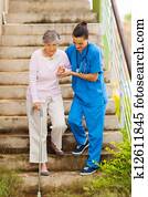 caring nurse helping senior patient