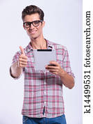 casual man holds tab and shows ok