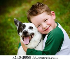 Child lovingly embraces his pet dog Child lovingly embraces his pet dog