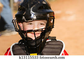 Child playing catcher during baseba