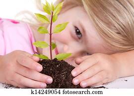 child with plant smiling