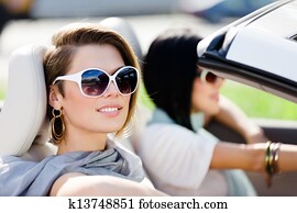 Close up of girls in sunglasses in the convertible car