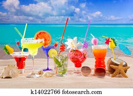 Colorful tropical cocktails at beach on white sand Colorful tropical cocktails at beach on white sand