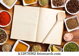 Cookbook and various spices and herbs. Cookbook and various spices and herbs.