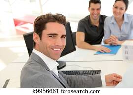 Couple in real-estate agency signing property loan contract