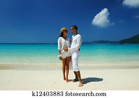 Couple in white on a beach