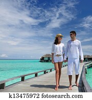 Couple on a beach jetty at Maldives