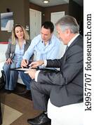 Couple with real-estate agent signing home investment contract